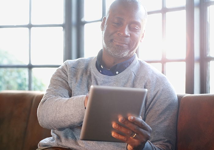 Man looking at ReadyMeds website on a tablet