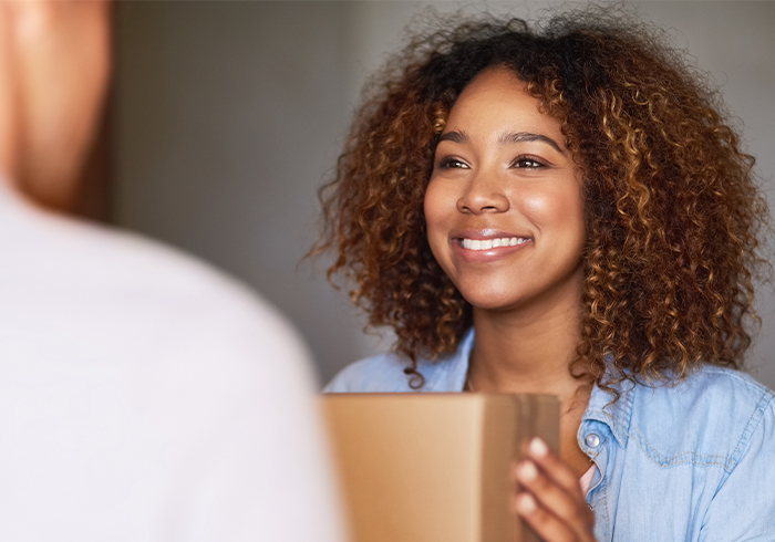 Young woman receiving ReadyMeds delivery.